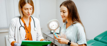 Médica enseñándole estudios a una paciente adolescente