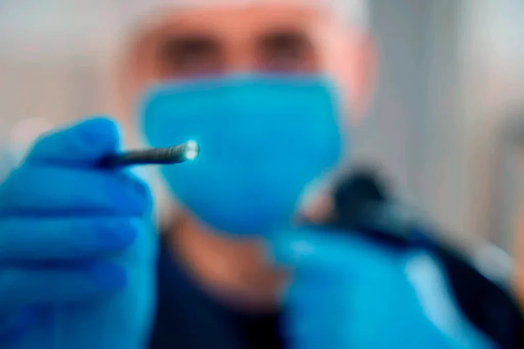 Doctor holding an endoscope, explaining what endoscopy is and what it is used for