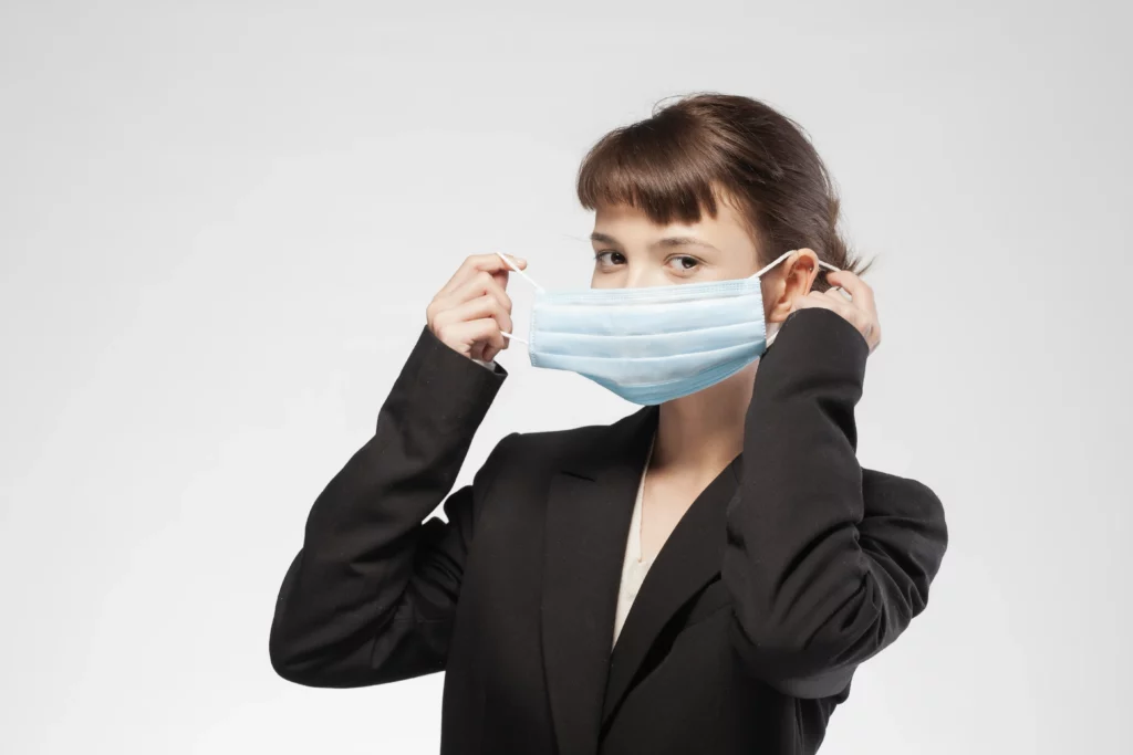 Due to the risk of H5N1, a woman puts on a face mask to prevent infection from this or other respiratory conditions.