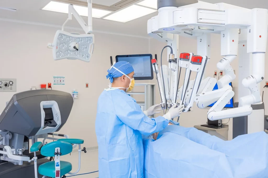 Da Vinci robotic surgery specialist preparing the robot’s arms for an upcoming surgical procedure
